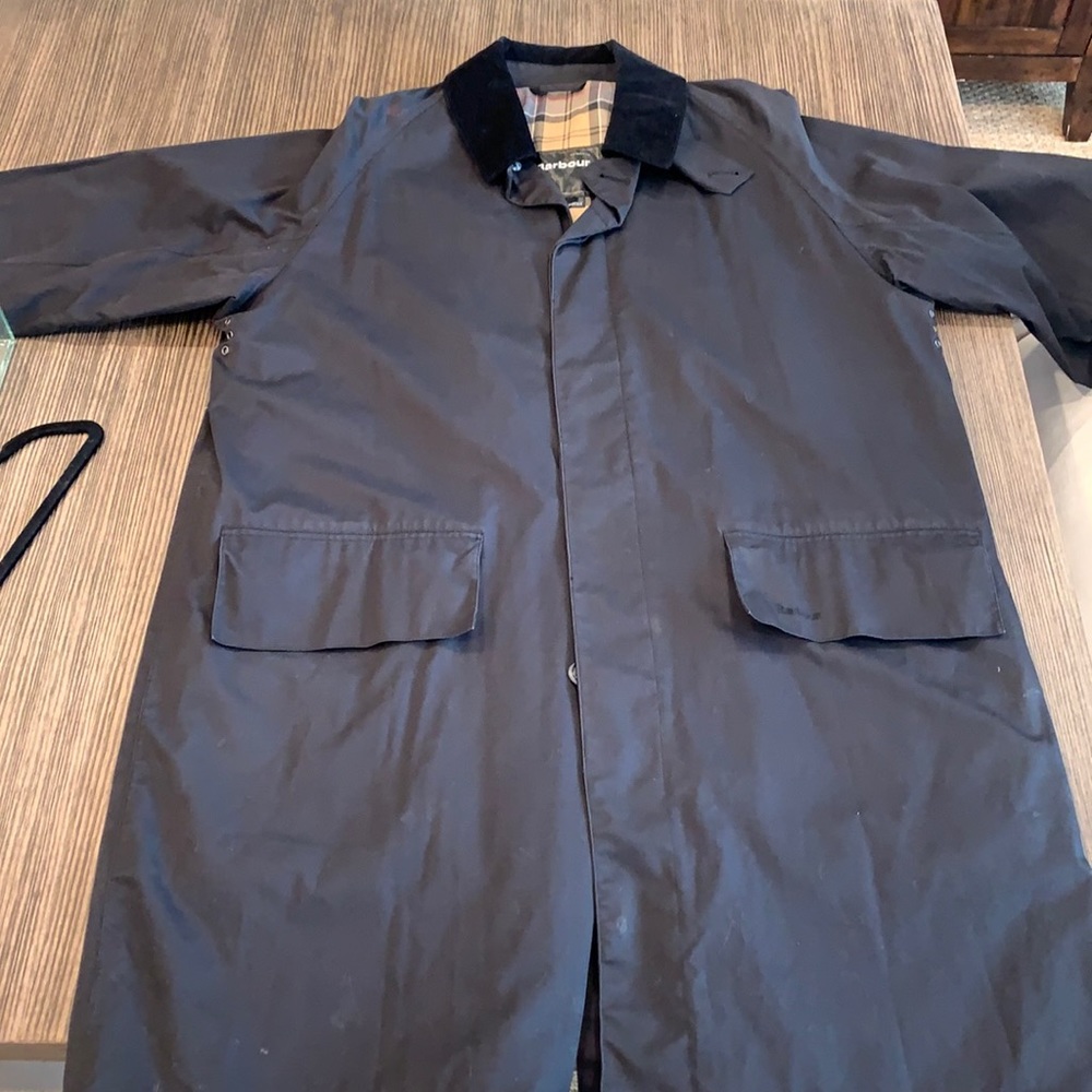 Black Barbour overcoat.